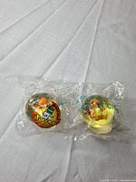 Two sealed Charmander capsule figures side by side in original bags