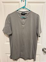 Front view of gray MAC+OO Henley shirt on hanger