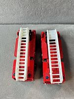 Top view showing both red fire engines with white ladders