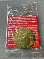 Front view of sealed coin in plastic with backing card visible