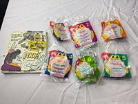 Overview of six sealed BeetleBorgs Happy Meal toys and mini comic booklet