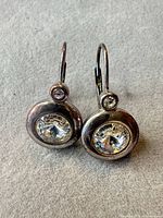 Front view of both earrings showing stones, bezel settings, and leverback hooks