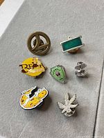 Group shot showing all seven enamel pins