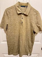 Front view of tan Perry Ellis polo shirt hanging