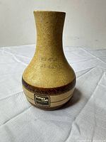 Full front view of vase showing shape, glaze colors and brand label