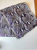 Folded scarf showing full animal print pattern and color palette