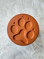 Front view showing terracotta paw print design