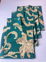 Stack of four folded napkins showing edges and pattern