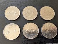 Six Canadian dollar coins reverse side showing years 1969, 1978, 1979, 1981