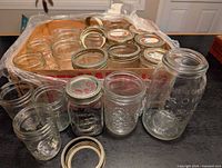 Group view of assorted jars and metal bands in crate