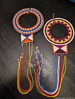 Both Maasai beaded necklaces laid flat showing full collars and tassels