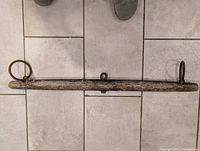 Full view of wooden yoke with iron rings at both ends and center