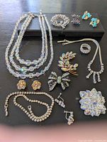 Group shot of all jewelry pieces laid out on black surface