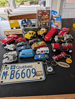 Full lot overview showing licence plate, packaged cars, loose vehicles and keychains