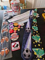Overview of ties, decals, pins, coasters and packaging