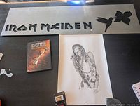 All three items laid out: Iron Maiden sign, Steven Tyler etching, Led Zeppelin DVD