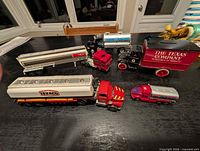 Group of six die-cast trucks showing relative sizes and liveries