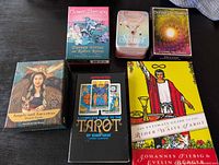 Six items: four oracle card decks and two tarot books