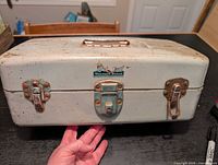 Front view of Mermaid Brand toolbox closed showing latches, handle and logo