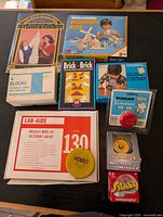 All boxed or sealed items laid out: Solar Powered Wooden Kits, A Blocks, Brick by Brick, Duncan yo-yo, Yomega yo-yo, Slinky, Lab-Aids kit, YOGO puzzle