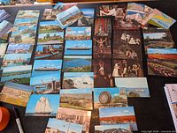 Spread of assorted colour postcards on table