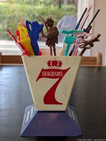 Front view of Seagram's 7 Crown caddy filled with multicolored swizzle sticks