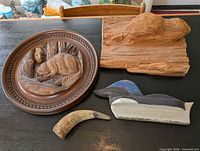 All four items: wooden beaver plaque, carved beaver sculpture, loon, horn