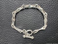 Entire bracelet laid flat on textured background