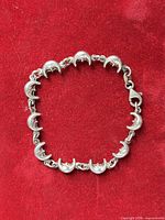 Full view of sterling silver moon link bracelet laid flat showing overall design