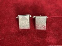 front view of both cufflinks on red background