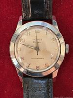 Front view showing dial, hands, numerals, case and strap