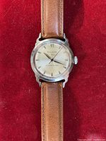 Front view showing dial, hands, strap