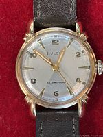 Front view showing dial, markers, hands, brand name, and selfwinding text