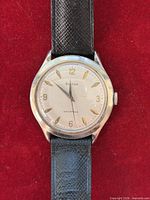 Front view of Bulova wristwatch on red background