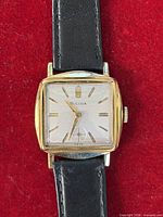 Front view showing dial, hands, case shape and strap