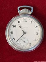 Front view showing dial, numerals, hands, brand marking