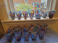 Full set on windowsill showing pitcher and 14 tumblers