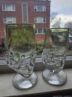 Pair of green-bowl goblets with clear hand stems front view