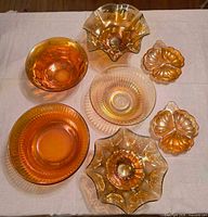 Group shot of all seven marigold carnival glass pieces