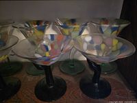 Group of multicolor millefiori stemware dishes on shelf