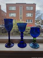 Front view of the three cobalt blue goblets on windowsill