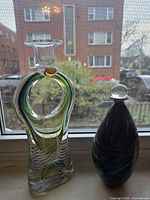 Front view of both glass vessels on windowsill