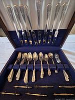 Full set in chest showing knives, forks, spoons, server, rests
