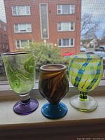 Front view of all three glasses showing colours and shapes