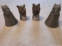 Front view of four animal head bottle stoppers