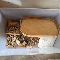 Overview of lot inside plastic tote showing rattan tray, dreamcatchers, HOG basket, canvas bag