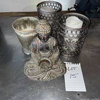 Full lot showing Buddha, vase and two candle holders with candles