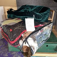 Overall lot with green velvet tote on top of clear bag containing textiles and plush toy