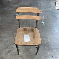 full view of child-size chair, metal frame, wooden seat and back