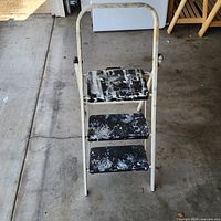 Front view of three-step folding ladder